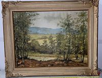 Full view of the vintage oil on canvas painting showing the landscape with trees and hills.
