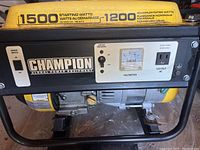 Champion generator control panel with labels indicating 1500 starting watts, 1200 running watts, 120-volt AC outlet, voltmeter and circuit breaker