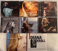 Photo showing eight Diana Krall CDs with album cover artwork visible.