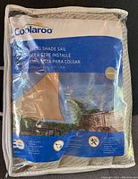 Front packaging showing product brand Coolaroo, product name, pebble color, and UV blocking feature.