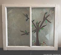 Front view of the stained glass window frame with tree motif featuring textured clear glass panels with colored glass sections for the tree and leaves.