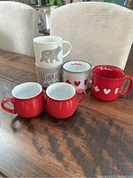 Overview of all mugs stacked and arranged on wooden table