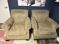 Front view of both beige armchairs showing upholstery, shape, and condition.