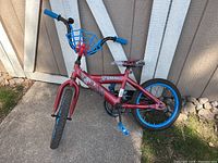 Full view of the red and blue Spider Man themed kids bike showing overall condition and colors.