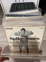 Photo of vinyl records showing Spike Jones album cover with black-and-white photo of performer in costume, records in plastic sleeves