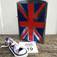 Front view of the large lighter showing the Union Jack design and the Converse shoe keychain placed in front.