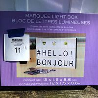 Marquee Light Box in box showing product size and usage example with letters and icons