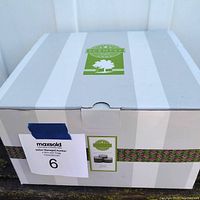 Original box of the Scentsy warmer showing minor wear from storage with MaxSold auction label