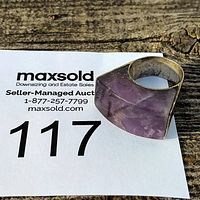 Front view of large purple and silver statement ring showing stone and band shape.