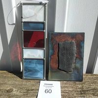 Photo of the stained glass panel and pottery wall hanging set placed on wooden surface, showing overall design and size context with measurement card.