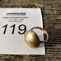 Side angle of the silver ring showing the domed top and tarnish.