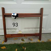 Front view of the teak folding table base, showing overall condition and height.