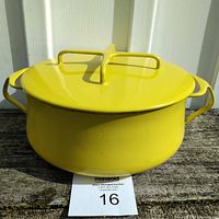 Full view of the yellow Dansk casserole dish with lid, showing the overall shape, color, and two side handles.
