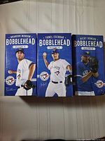 Photo of all three bobblehead boxes featuring Yunel Escobar, Rickey Romero and Brandon Morrow in original packaging