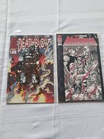 Two Image Comics issues side by side: Deathblow #2 on left, Bloodstrike #1 on right, on a white cloth background.