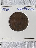 Front side of the 1929 George V half penny coin showing '1929 HALF PENNY' with some wear.