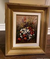 Framed floral painting showing full frame and artwork with flowers including white daisies and red poppies.
