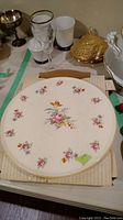 Photo showing Gloria collector plate with floral pattern and gold trim.