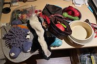 View of plush and rubber dog toys along with two small bags