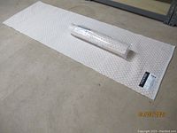Both Safavieh runners, one unrolled and one rolled, on a concrete floor showing size and condition.
