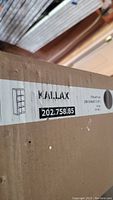 Close-up photo of the Ikea Kallax box label showing model number 202.758.85 and shelving dimensions 77x147 cm (30x58 inches).