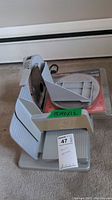 Chef's Choice #610 electric slicer showing blade, sliding tray, and extra blades in packaging.