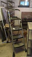 Full view of the Cosco step ladder showing its four steps and height.