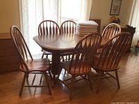 Full set showing table, six chairs, and stacked chair pads