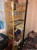 Full view of wood shelving unit with items on the shelves and vertical slat sides visible.