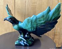 View of the eagle figurine from the left side showing wing and body coloration.