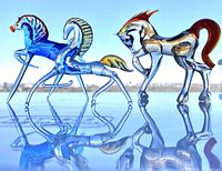 Three hand blown glass horse figurines including a blue one, a clear one with yellow accents, and a clear one with orange accents.