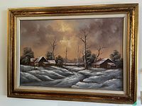 Frontal image of the framed oil painting showing a snow-covered rural landscape with rustic buildings and trees under a cloudy sky.