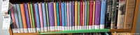 Shelf showing 20 books from Vancouver Sun classic literature collection, multicolored volumes ranging from 1 to 20 in series, including famous classic titles.