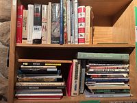 Books of various topics including cookbooks, crafting, art, and history arranged on shelves.