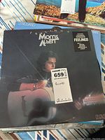 Morris Albert 'Feelings' album with a dark cover featuring Morris Albert holding a guitar; includes a pricing sticker.