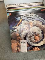 Photo showing front covers of several vintage vinyl records including The Moody Blues - A Question of Balance