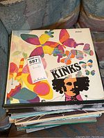 Stack of vinyl record albums showing The Kinks "Face to Face" as the topmost album