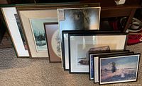 Photo showing nine framed prints standing against a wall, various styles and sizes consistent with seller description.