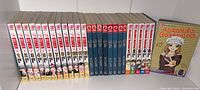 Spine view of Otomen volumes 1-12, Chobits volumes 1-8, and an Absolute Boyfriend volume 6 cover.