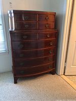 Front view of Williamsport Furniture Company highboy dresser showing entire piece with drawer arrangement and brass hardware.