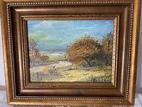 Full view of the oil painting in its decorative wood frame showing the landscape scene with a path, trees, and cloudy sky.