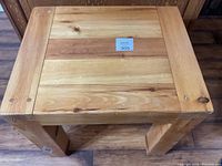 Top view of pine end table showing wood grain and wear marks