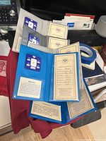 Five certificates with gemstone display cards showing authenticity and gem data details for Citrine, Zircon, Moonstone, Quartz and Amethyst stones.