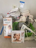 Grouped photo of bedding, kitchen linens, and electrical personal care items.