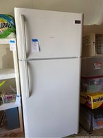 Front view of white Frigidaire refrigerator-freezer in garage