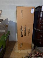 Tall cardboard box with NordicTrack branding and patent numbers on side.