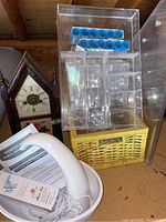 Full view of lot including swan fountain, vintage clock, and acrylic drawer organizers