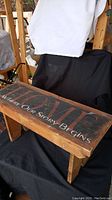 Wooden bench top surface showing text 'HOME Where Our Story Begins'