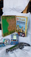 Lego Chima storage box with jungle interior, Space Invader handheld game, Monster High cards visible