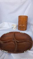 Full view of the lot showing the brown ceramic tiki mug, wooden divided candy dish with decorative inlays, and small white ceramic mini cup 'Aloha'